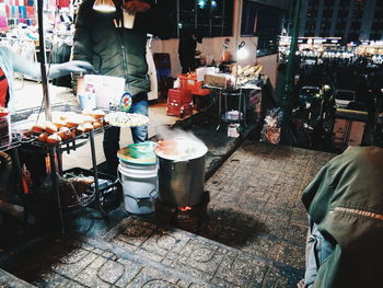 Man working at market stall in city