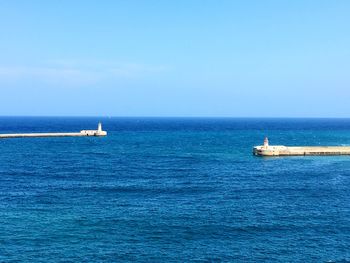 Scenic view of sea against blue sky