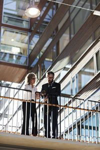 Low angle view of business people discussing at office lobby