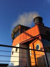 Low angle view of tower against blue sky