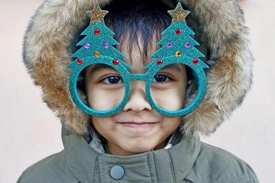 Portrait of boy wearing christmas tree glasses