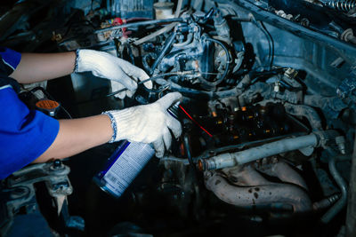 Midsection of man repairing car