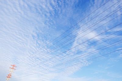 Low angle view of airplane flying against blue sky