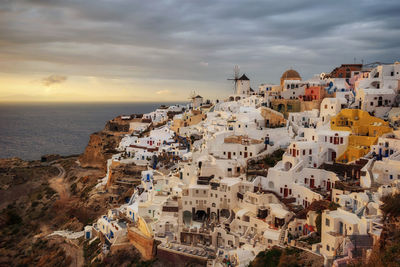 High angle view of buildings against cloudy sky