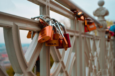 Close-up of padlocks hanging on railing