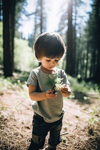 Portrait of cute girl playing in forest