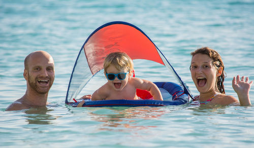 Portrait of family enjoying in sea