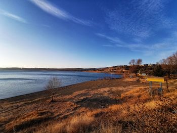 Scenic view of beach against blue sky