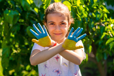 Portrait of cute girl holding plant