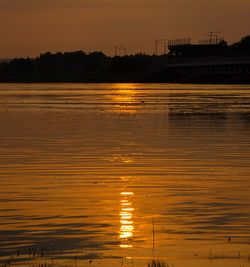 Scenic view of lake against orange sky