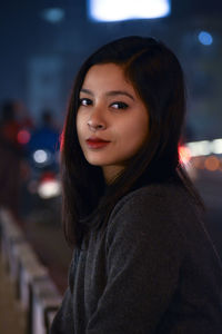 Portrait of young woman at night