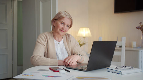 Businesswoman using laptop at office