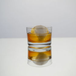 Close-up of beer glass against white background