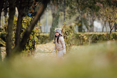 Sad little girl walking in the park