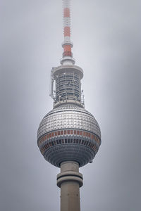 Low angle view of communications tower against sky