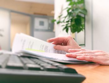 Midsection of woman using smart phone on table