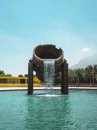 Fountain at park against sky