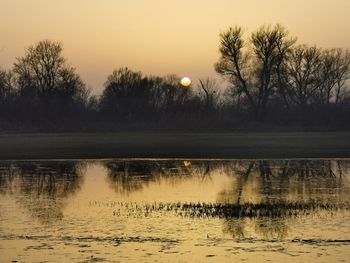 Scenic view of lake against sky during sunset