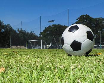 A soccer ball on the grass of a soccer field