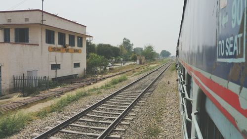 Train on railroad tracks against clear sky