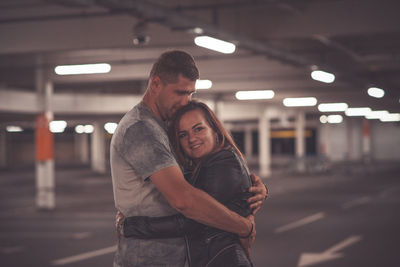 Couple embracing in parking lot
