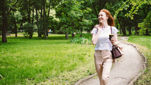 Portrait of a smiling young woman standing in park