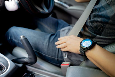 Midsection of man sitting in car