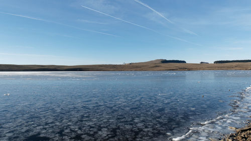 Scenic view of frozen lake against sky