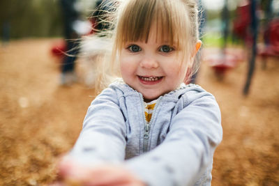 Close-up portrait of girl standing at park