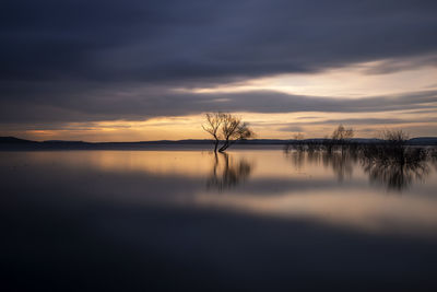 Scenic view of lake against sky during sunset