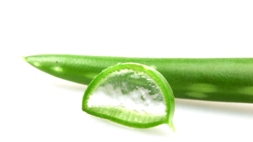 Close-up of green pepper against white background