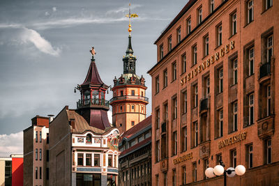 Low angle view of buildings in city against sky