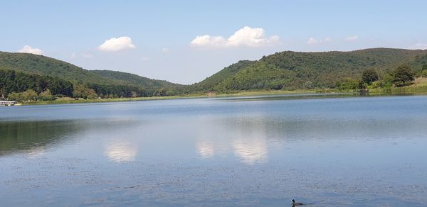 Scenic view of lake and mountains against sky