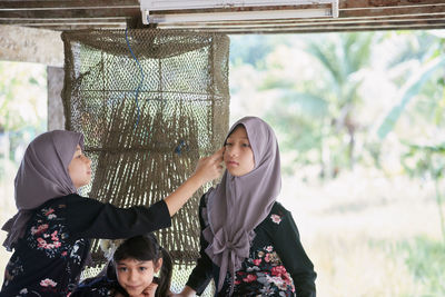 Elder sister and younger sister wearing hijab fashion at home area