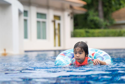 Little adorable girl have fun at outdoor swimming pool