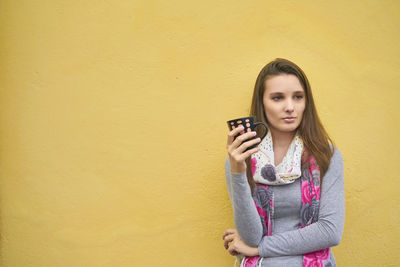 Portrait of young woman holding mug