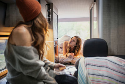 Friends spending leisure time in camper van