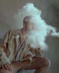 Portrait of young man sitting outdoors