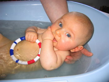 Portrait of cute baby boy in bathroom