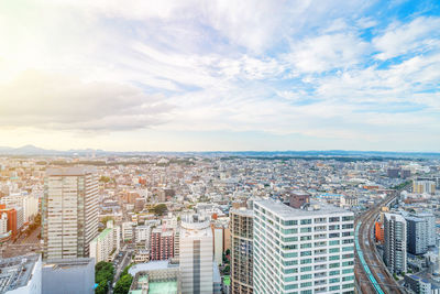 High angle view of city buildings against sky