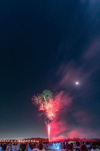 Low angle view of firework display at night