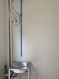 Close-up of white pipes on wall at home