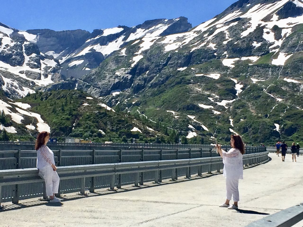 REAR VIEW OF COUPLE ON MOUNTAIN ROAD