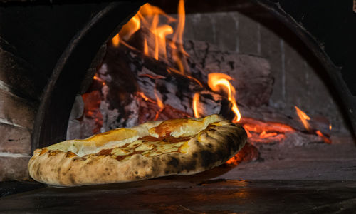 Close-up of pizza by oven