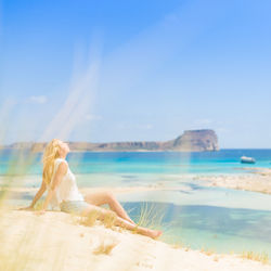 Woman on beach against sky