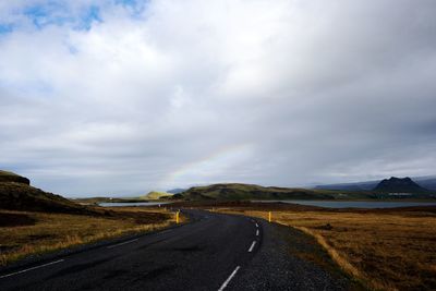 Empty road along countryside landscape