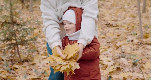 Low section of woman picking leaves