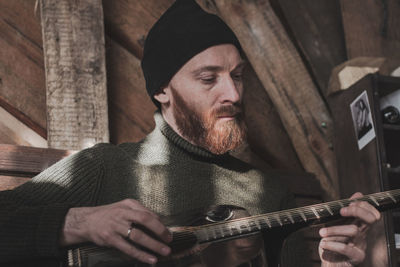 Portrait of man playing guitar