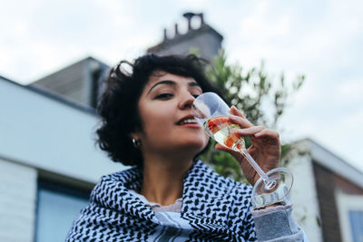 Portrait of beautiful woman drinking glass