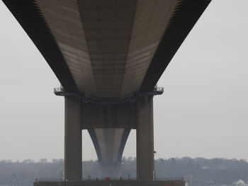 Low angle view of bridge against sky in city